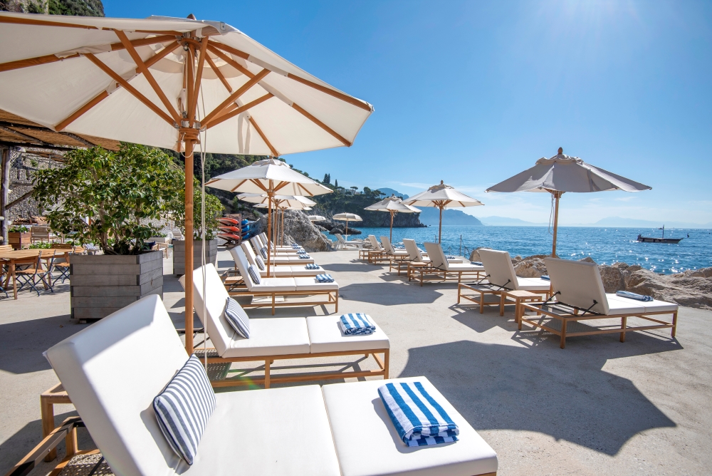 Beach terrace at Borgo Santandrea with sun loungers and Mediterranean Sea views