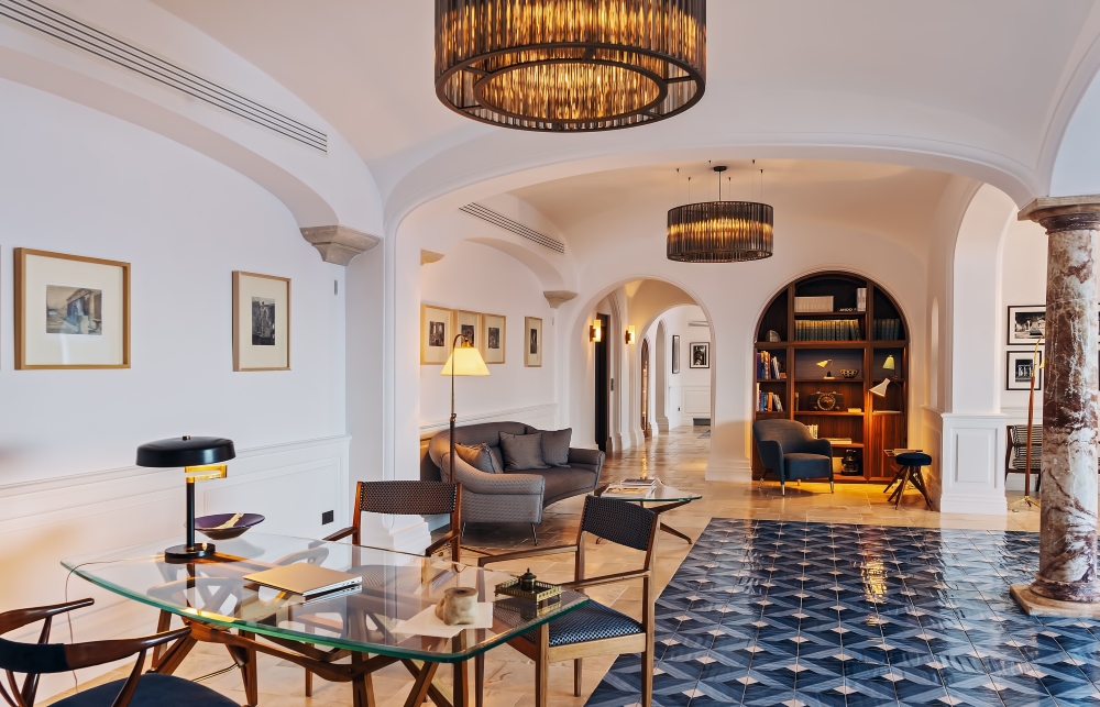 Reception lounge at Borgo Santandrea, featuring arched ceilings and blue-and-white tiled floors