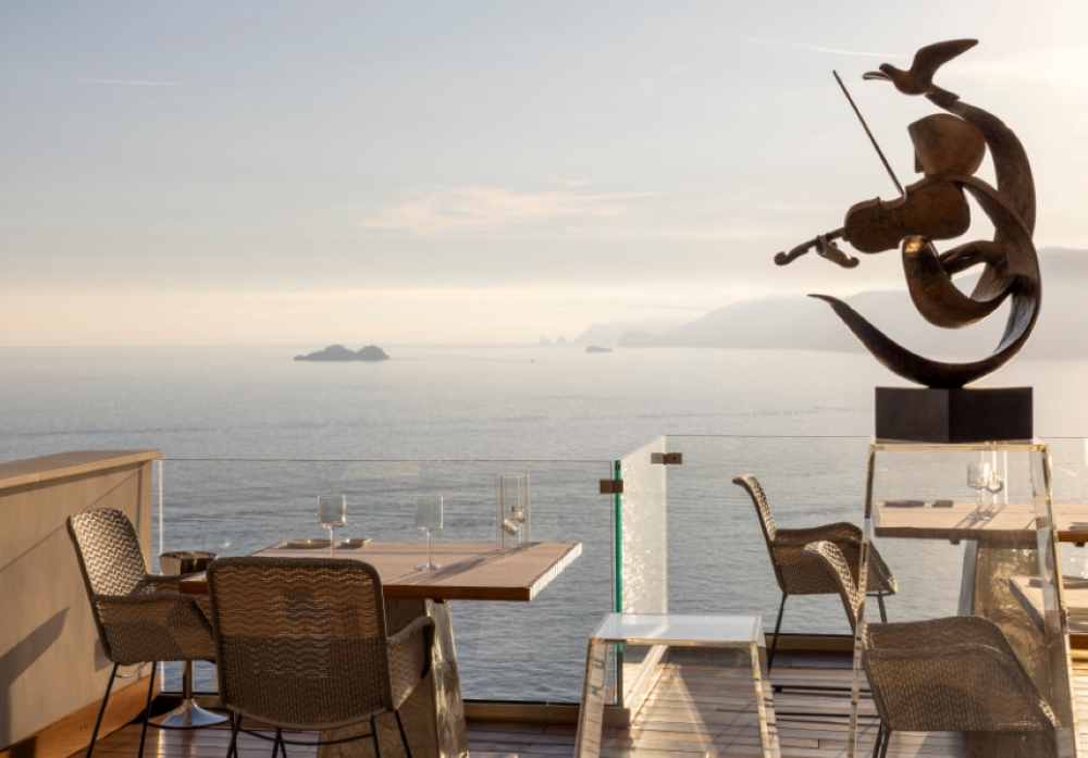 Seaside dining terrace at Casa Angelina in Praiano, overlooking the Mediterranean Sea on the Amalfi Coast, Italy