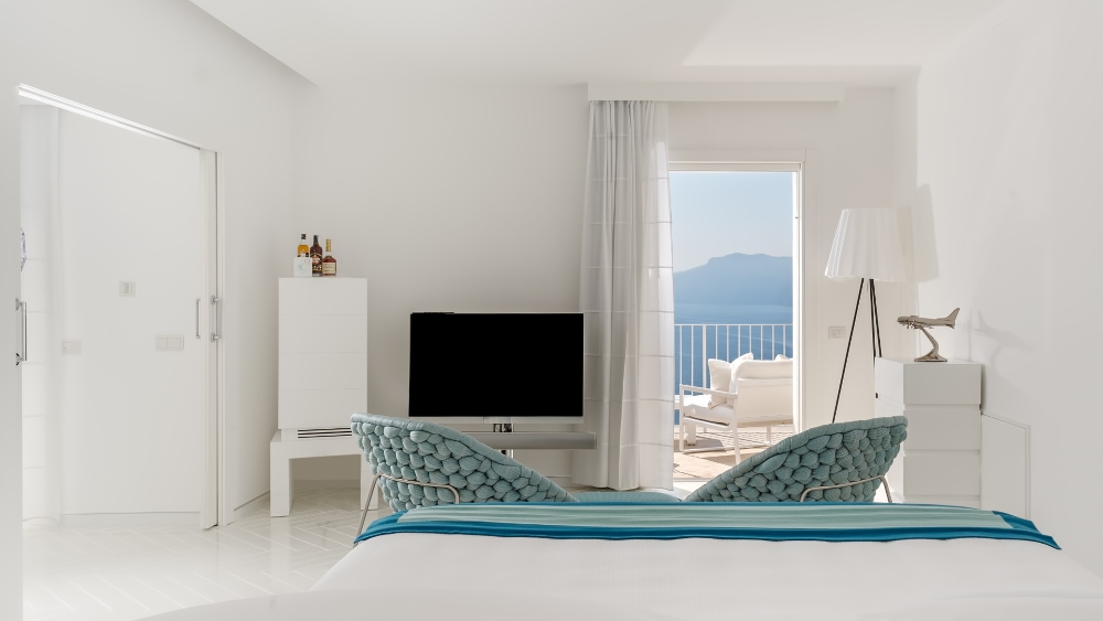 Minimalist white suite at Casa Angelina in Praiano with views of the Mediterranean Sea on the Amalfi Coast, Italy