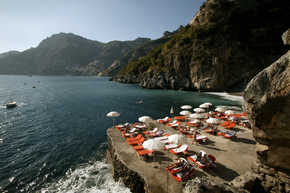 Private beach at Il San Pietro di Positano, with sun loungers beside the Mediterranean Sea