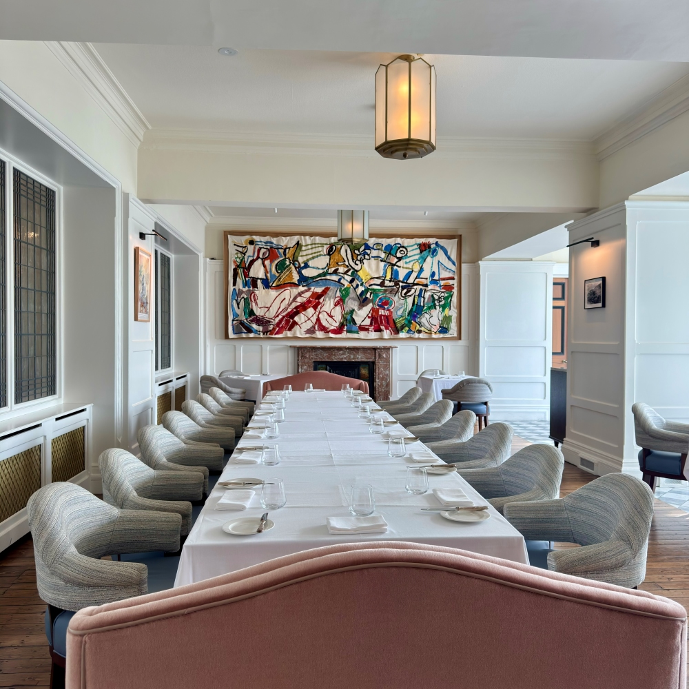 Elegant dining room at Landline restaurant at Park Hotel Kenmare with a long table, contemporary seating and colourful artwork in County Kerry, Ireland
